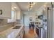 Modern kitchen featuring stainless steel appliances, white cabinetry, and granite countertops at 1013 Homestake Dr # 17C, Golden, CO 80401