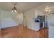 Open concept living space featuring hardwood floors, white cabinetry, and stairs at 1013 Homestake Dr # 17C, Golden, CO 80401