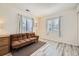 Bright bedroom with wood-style flooring and a comfortable brown sofa at 3600 S Pierce St # 106, Lakewood, CO 80235