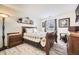 Inviting bedroom with wood furniture and a comfortable bed at 3600 S Pierce St # 106, Lakewood, CO 80235