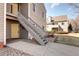 Charming condo with a yellow front door and grey wood siding at 3600 S Pierce St # 106, Lakewood, CO 80235