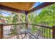 Charming balcony with outdoor seating offers serene views of the surrounding trees and landscape at 180 Broken Lance Dr # 14, Breckenridge, CO 80424