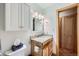 A bright bathroom featuring a single-sink vanity, overhead cabinet, and updated mirror at 180 Broken Lance Dr # 14, Breckenridge, CO 80424