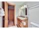 A bathroom featuring a single sink vanity and a wood-trimmed door leading to a closet at 180 Broken Lance Dr # 14, Breckenridge, CO 80424