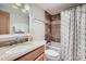 This bathroom features a shower and tub, granite vanity top, and decorative shower curtain at 180 Broken Lance Dr # 14, Breckenridge, CO 80424