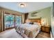 Comfortable bedroom with balcony access, wooden accents, and ski decor at 180 Broken Lance Dr # 14, Breckenridge, CO 80424