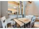 Open dining area with a wooden table and chairs, adjacent to the kitchen with modern appliances at 180 Broken Lance Dr # 14, Breckenridge, CO 80424
