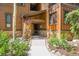 Inviting entrance with stone accents, wood siding, and a flower basket detail leads into the building at 180 Broken Lance Dr # 14, Breckenridge, CO 80424