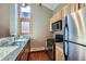Kitchen featuring granite countertops, stainless steel appliances, and wood flooring, with natural light from a window at 180 Broken Lance Dr # 14, Breckenridge, CO 80424