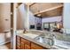 Kitchen view showing granite countertops, wooden cabinets and a view into the living room with a stone fireplace at 180 Broken Lance Dr # 14, Breckenridge, CO 80424