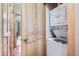 Efficient laundry area featuring a stacked washer and dryer set with wooden trim and door at 180 Broken Lance Dr # 14, Breckenridge, CO 80424