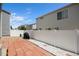 Brick patio with white stone landscaping and white vinyl privacy fence at 4076 Andes Way, Denver, CO 80249