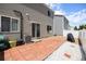 Brick patio with white stone landscaping and white vinyl privacy fence at 4076 Andes Way, Denver, CO 80249