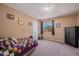 Carpeted bedroom with neutral colored walls, and window with views of the outdoors at 4076 Andes Way, Denver, CO 80249