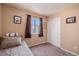Serene bedroom with a closet, soft carpet, and a sunny window at 4076 Andes Way, Denver, CO 80249
