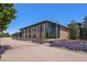 Building exterior with manicured landscaping and sidewalk benches at 4076 Andes Way, Denver, CO 80249