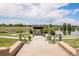 Scenic community pond featuring walking paths, lush greenery, and a charming gazebo under a partly cloudy sky at 4076 Andes Way, Denver, CO 80249