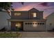 Charming two-story home with a well-maintained lawn and two-car garage against a beautiful evening sky at 4076 Andes Way, Denver, CO 80249