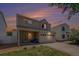 Charming two-story home with a well-maintained lawn and two-car garage under a beautiful sunset sky at 4076 Andes Way, Denver, CO 80249