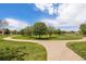 Expansive green space showcasing manicured lawns, walking paths, and mature trees under a partly cloudy sky at 4076 Andes Way, Denver, CO 80249