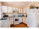 Charming kitchen with granite counters, white cabinets, and modern appliances at 4076 Andes Way, Denver, CO 80249