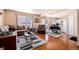 Comfortable living room with hardwood floors, a modern sofa set, and an open floor plan to the kitchen at 4076 Andes Way, Denver, CO 80249
