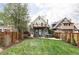 Beautiful backyard with a well-manicured lawn, a patio, a hot tub, and mature trees at 3005 Grove St, Denver, CO 80211