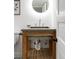 Stylish bathroom with wood vanity, unique sink, and a modern mirror at 3005 Grove St, Denver, CO 80211