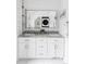 Elegant bathroom featuring double sinks, granite countertop, and ample storage space at 3005 Grove St, Denver, CO 80211