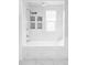 Modern bathtub and shower with marble tile and decorative inserts at 3005 Grove St, Denver, CO 80211