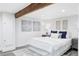 Cozy bedroom featuring a beamed ceiling, stylish decor, a comfortable bed, and lots of natural light at 3005 Grove St, Denver, CO 80211