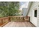 Outdoor deck, wooden railing and flooring, looking out to a neighborhood tree at 3005 Grove St, Denver, CO 80211