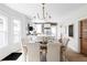 Elegant dining room featuring hardwood floors, tufted chairs, and an ornate chandelier at 3005 Grove St, Denver, CO 80211