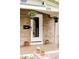 Inviting front porch with brick facade, hanging plants, and potted flowers that add to the home's curb appeal at 3005 Grove St, Denver, CO 80211