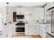 Bright kitchen with white cabinets, stainless steel appliances, and a wooden wine rack at 3005 Grove St, Denver, CO 80211