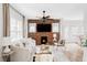 Cozy living room with a brick accent wall, modern fireplace, and hardwood floors that provide a warm ambiance at 3005 Grove St, Denver, CO 80211
