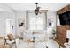 Bright living room with white walls, hardwood floors, a cozy couch, and a decorative brick wall at 3005 Grove St, Denver, CO 80211