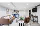 Finished basement living room with cozy seating, brick accent wall, and wet bar at 3005 Grove St, Denver, CO 80211