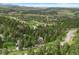 Community aerial view showcases a mountain neighborhood surrounded by mature trees at 1129 Genesee Vista Rd, Golden, CO 80401