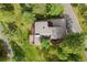Aerial view of the home and yard with surrounding treeline at 1129 Genesee Vista Rd, Golden, CO 80401