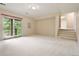 Finished basement area with a sliding glass door and stairs at 1129 Genesee Vista Rd, Golden, CO 80401