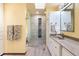 Bright bathroom featuring double sinks, generous vanity space, and glass door shower at 1129 Genesee Vista Rd, Golden, CO 80401