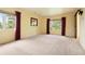 Bright bedroom featuring neutral carpet, sunny windows, and beautiful backyard view at 1129 Genesee Vista Rd, Golden, CO 80401
