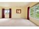 Sunny bedroom with plush carpeting, large windows, and exterior views at 1129 Genesee Vista Rd, Golden, CO 80401
