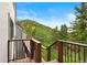 Deck with railing, with a treed hillside view at 1129 Genesee Vista Rd, Golden, CO 80401