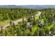 Picturesque home tucked away in a green, wooded area, featuring a cozy deck and scenic surroundings at 1129 Genesee Vista Rd, Golden, CO 80401