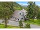 Charming home featuring a unique roofline surrounded by mature trees at 1129 Genesee Vista Rd, Golden, CO 80401