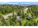 Beautiful home nestled in a wooded landscape with a view of winding roads and surrounding greenery at 1129 Genesee Vista Rd, Golden, CO 80401
