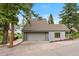 Grey home with a garage, deck, and an American flag waving in the breeze at 1129 Genesee Vista Rd, Golden, CO 80401