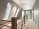 Bright hallway featuring skylights, wood railing and view of the surrounding landscape at 1129 Genesee Vista Rd, Golden, CO 80401
